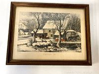 Full view of the framed print depicting a winter rural scene with farm animals and water wheel.