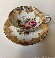 Side view of vintage Paragon fine bone china cup and saucer showing floral and gold detailing