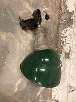 Full view of the vintage green metal light fixture with clamp mount, showing entire piece and mounting bracket.