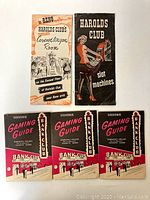 Five vintage casino pamphlets from Harolds Club and Bank Club arranged on a white surface, showing front covers with casino advertising and gaming guides