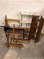 Group photo of all 5 wooden shelves showing the variety of styles and finishes including natural wood, white painted, and dark blue painted pieces.