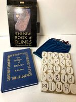 Photo showing the book, rune stones, blue pouch, and original box with the title and image clear.