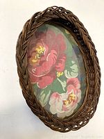 Overhead view of the entire oval wicker tray showing the woven pattern and floral fabric insert under glass.