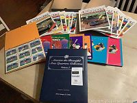 Photo showing entire lot including Automobile magazines arranged in two rows on table, 7 Looney Tunes Comic Ball Card Albums in colorful covers and large blue State Quarters Collection coin album front cover.