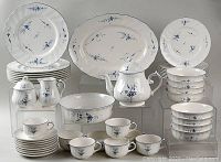 Angled view of full Villeroy & Boch Vieux Luxembourg dinnerware set arranged with plates, bowls, cups, saucers, tea pot, pitchers, fondue pot, and platters