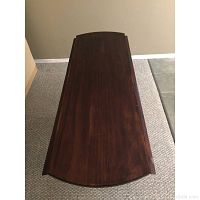 Dining table with both leaves folded down, showing a narrow rectangular surface.