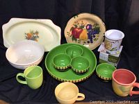 Collection of colorful vintage and modern ceramic serving pieces including platters, bowls, cups, and salsa serving items on a black background.