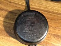 Bottom of the large Wagners cast iron skillet showing brand, date 1891, seasoning instructions, and size 10.5 inch chicken fryer.