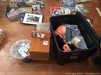 Full view showing wooden sewing box, button tins, thread organizer, and black plastic tote with fabric and sewing materials