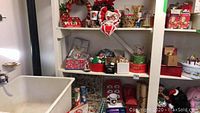 Shelves with various Christmas ornaments, decorative boxes, and accessories