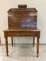 Front view of the desk with closed drop front and two lower drawers