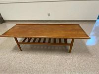 Front view of entire table showing top, legs, and lower shelf