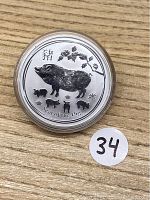 Obverse side of 2019 Australian Silver Dollar coin showing the Year of the Pig design with pig and piglets and Chinese character for pig.