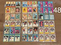 Overview photo showing 48 hockey cards arranged on a wooden floor with a number 48 marking indicating item count.
