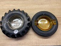 Two Firestone tire ashtrays on a wooden surface, one clear and one amber, showing overall shape and size.