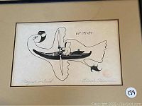 Full view of framed black and white print showing a stylized bird with a kayak and figure inside.