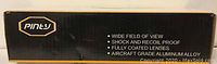 Close-up of the box side showing Pinty brand and product features: wide field of view, shock and recoil proof, fully coated lenses, aircraft grade aluminum alloy construction.