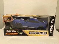 Photo of boxed blue Ford Shelby GT500 remote control car in original packaging showing New Bright branding and 1:12 scale label.