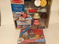Photo showing Melissa & Doug Ice Cream Play Set in box with colorful plastic ice cream scoops and accessories