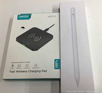 Photo of retail boxes showing Choetech wireless charging pad and white stylus pen box.