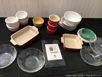 Full view showing all pottery, stoneware, and glassware items arranged on a black cloth.