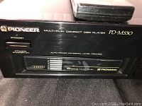Close-up of the front left side showing the Pioneer logo, PD-M530 model, standby power switch, and 6 disc multi-play carousel.