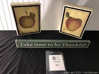 Three-piece set displayed including two framed apple wall hangings and one kitchen sign with thankful message