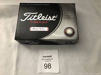 Closed box of Titleist Pro V1x golf balls on white background.