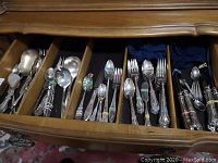 Drawer view showing assorted flatware organized by type