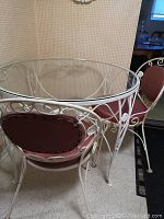 Table and 3 chairs positioned together showing upholstery and metal frame condition
