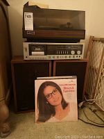 Photo showing turntable, receiver, speakers, and Nana Mouskouri album in front