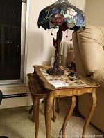 Two nesting tables with Tiffany style lamp on top