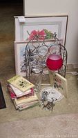 Photo showing all items together including framed art, chrome wine rack, cocktail accessories, drinking glass, and stacks of decorative paper napkins.