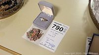Ring and necklace displayed together with MaxSold lot card