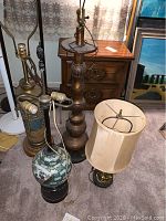 Photo showing all four table lamps grouped on carpet, highlighting varied styles and heights.