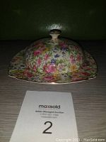 Butter dish with floral chintz pattern, dome lid, and square plate base, front angle.