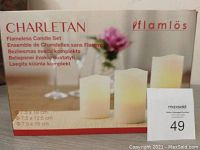 Packaging box showing Charletan Flamös flameless candle set with three candles of varying heights.