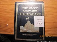 Front cover of The Globe Illustrated Shakespeare book showing title text and theater illustration.