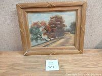 Framed landscape painting showing a tree-lined path by water, signed P. Pernat 1911.