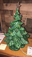 Front and side views of vintage green ceramic Christmas tree with colorful bulb inserts and clear star topper.