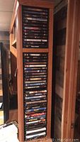 Long wooden shelf filled with DVDs, titles include Star Wars, Indiana Jones, Harry Potter, Lord of the Rings