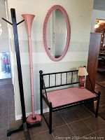 Set of all items including pink floor lamp, wood coat tree, pink oval mirror, black metal bench with pink cushion, and pink table lamp
