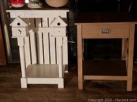 White wooden birdhouse-style accent table with two birdhouses on top, slatted back, and bottom shelf