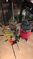 Full view of lot showing Shop Vac, multiple yard tools including loppers, rake, pruning shears, hedge trimmer and electric chainsaw.