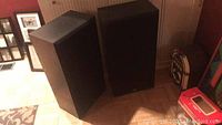 Two large black rectangular KLH speakers, shown from the front with fabric grills.