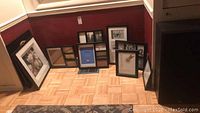 Seven picture frames including multi-pane and single pane designs, arranged on floor in a corner