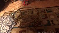 Full view of round rattan coffee table with glass top showing structure and size.