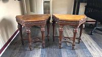 Pair of vintage wood side tables side by side showing full height and carved legs