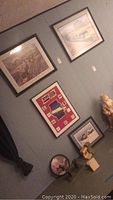 Wall displaying multiple framed train and railroad-themed prints and patch collection, with some rail memorabilia below