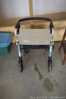 Front view of the lightweight aluminum frame mobility chair showing black handlebar and four wheels.